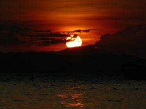 The sun is setting over a body of water